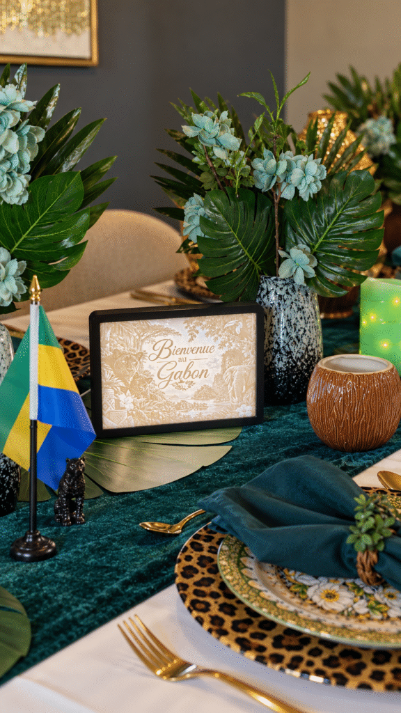 Illuminated Bienvenue au Gabon lithophane in a black frame styled with the Gabon flag and tropical table decor